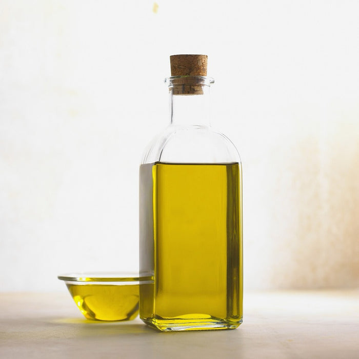 Golden cold-pressed oil in a glass bottle